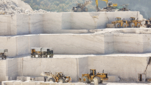 heavy construction machinery trucks loaders white marble quarry layers